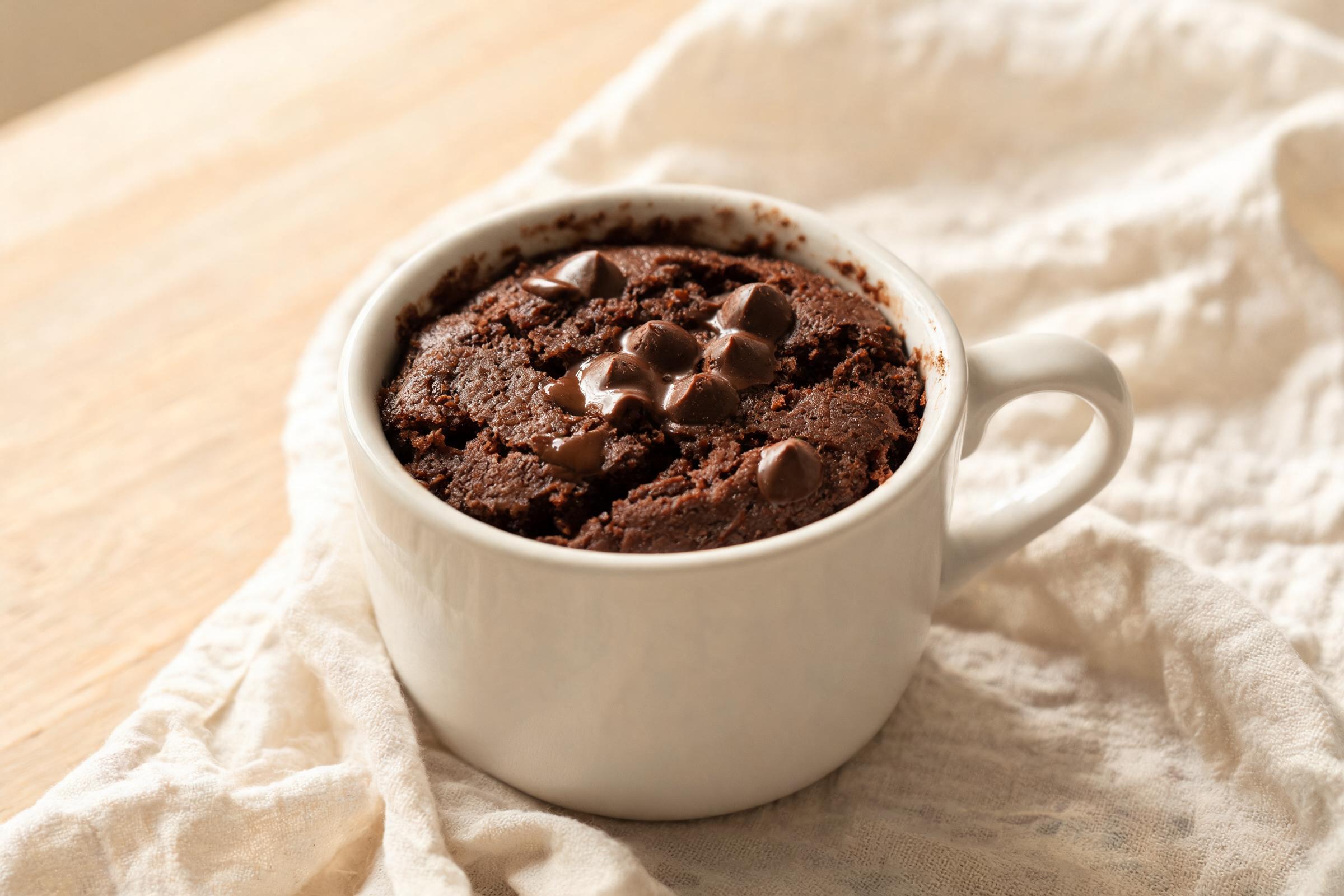 Double chocolate fudge mug cake with glossy melted chocolate chips on top