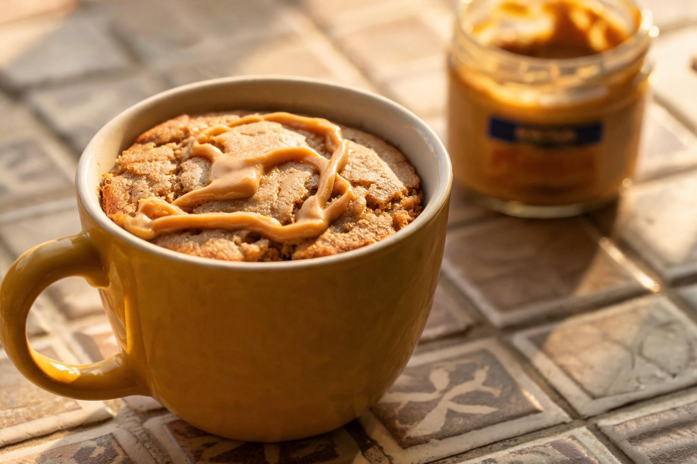 Peanut butter swirl mug cake with a golden peanut butter ribbon